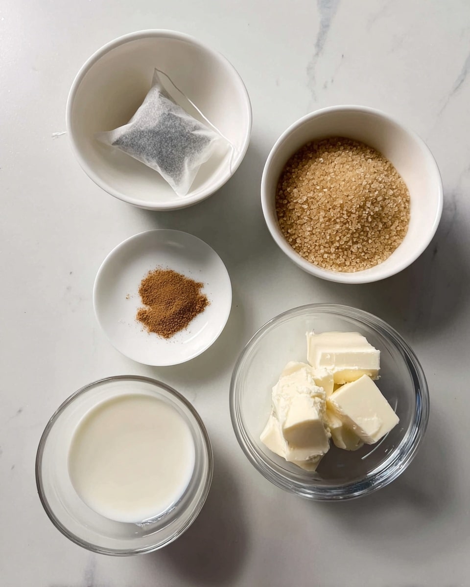 The image shows five small white bowls and clear glasses on a white marbled surface, each holding a different ingredient. At the top left is a white bowl with a tea bag inside, and at the top right is another white bowl filled with light brown sugar crystals. In the middle is a small white saucer with a small amount of brown powdered spice spread lightly in the center. At the bottom left is a clear glass cup with a white liquid, likely milk or cream. At the bottom right is a short clear glass containing off-white, soft chunks, possibly butter or cream. The overall scene is clean with ingredients carefully placed in a neat arrangement. Photo taken with an iphone --ar 4:5 --v 7
