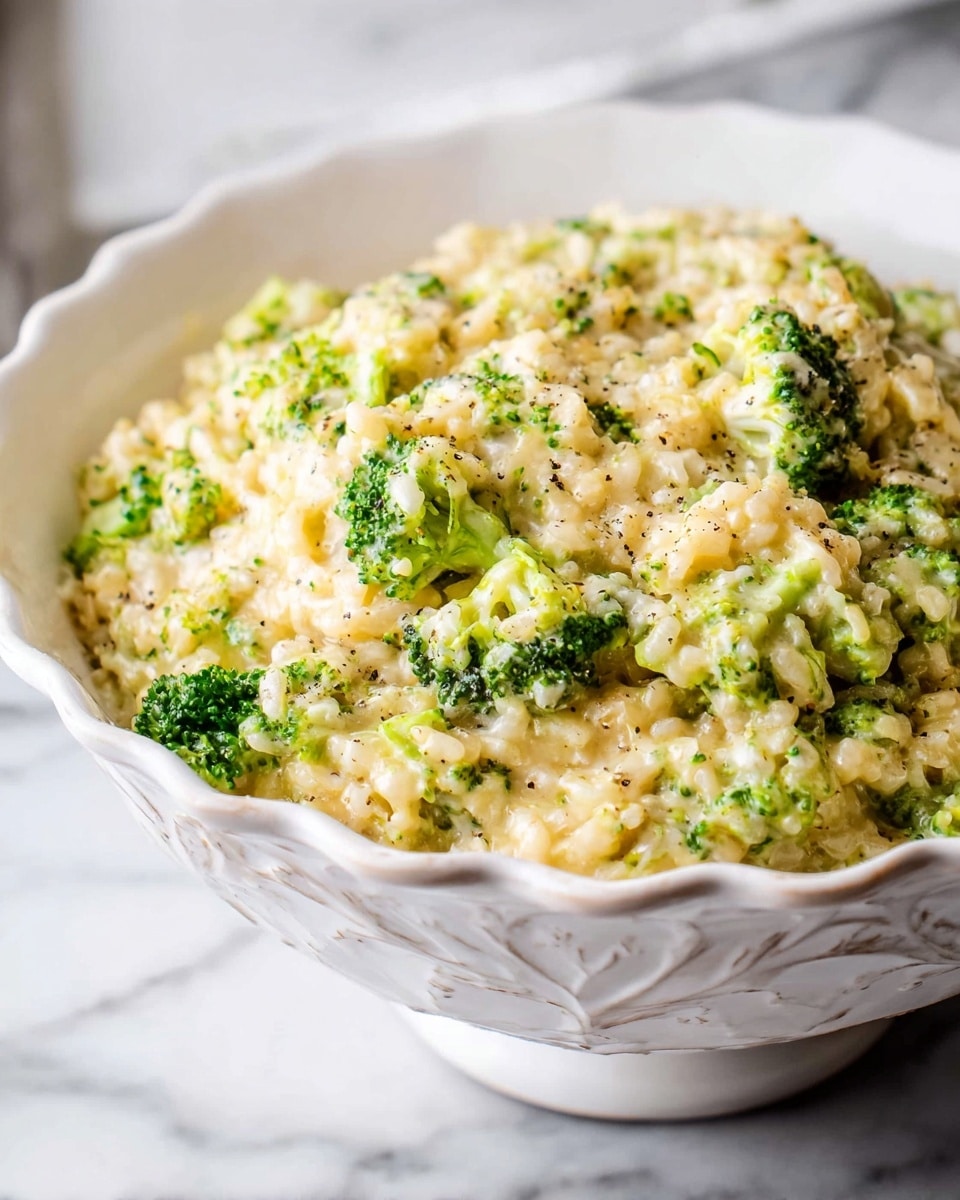 Large white ornate serving bowl filled with a creamy broccoli and rice casserole, showcasing tender broccoli florets and fluffy rice mixed evenly in a rich cheese sauce, garnished lightly with cracked pepper, photographed at a 3/4 angle on a white marble countertop with natural lighting, professional food magazine hero shot, photo taken with an iphone --ar 4:5 --v 7