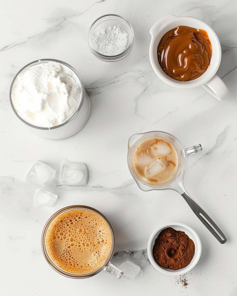 Single white glass filled with a layered iced coffee drink showing the distinct separation of cold milk at the bottom and rich espresso ice cubes swirling through the medium coffee layer, topped with a generous swirl of whipped cream drizzled with smooth caramel sauce, close-up shot emphasizing the texture of the cream and melting ice, placed on a white marble surface, intimate plated serving photo taken with an iphone --ar 4:5 --v 7