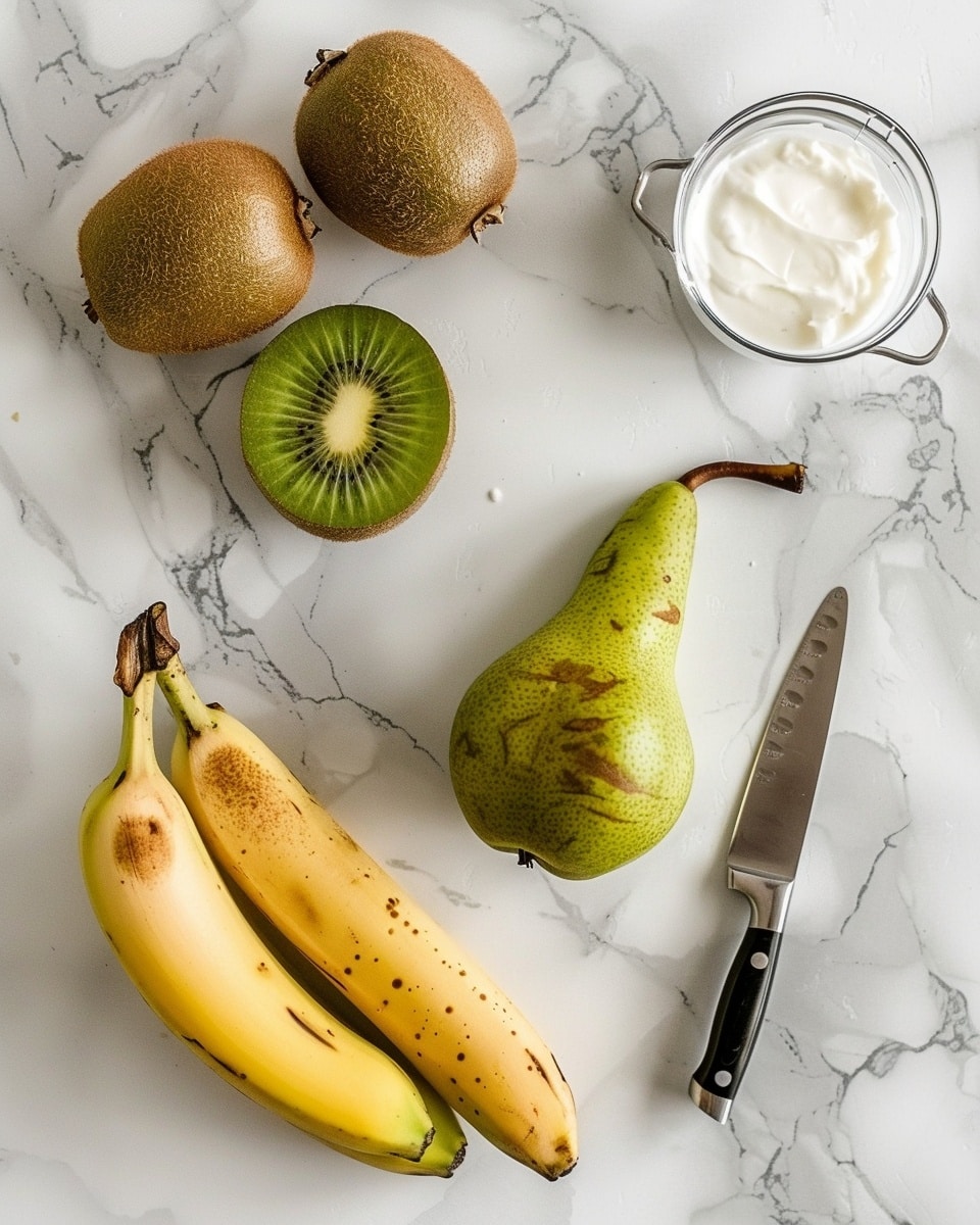 Single clear glass filled with a creamy banana and kiwi smoothie, showing a smooth texture with tiny specks of kiwi seeds visible throughout, topped with a fresh, vibrant kiwi slice resting on the rim, placed on a white marble surface with blurred bananas and whole kiwis softly out of focus in the background, natural lighting highlighting the fresh and refreshing nature of the drink, intimate close-up view, photo taken with an iphone --ar 4:5 --v 7